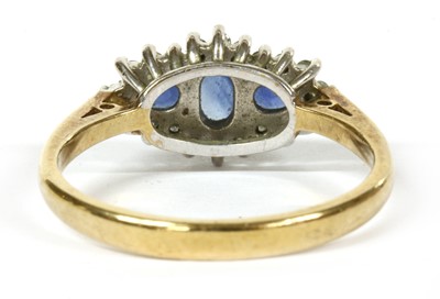 Lot 109 - A 9ct gold sapphire and diamond three stone cluster ring