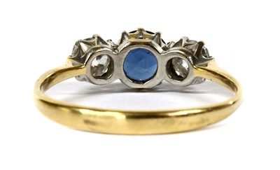 Lot 30 - A gold three stone sapphire and diamond ring