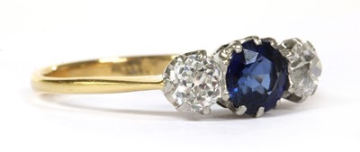 Lot 30 - A gold three stone sapphire and diamond ring
