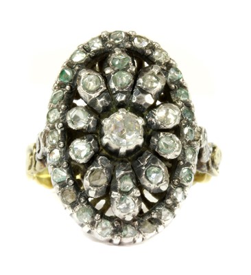 Lot 132 - A gold and silver diamond oval cluster ring