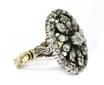 Lot 132 - A gold and silver diamond oval cluster ring