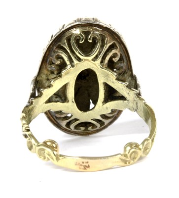 Lot 132 - A gold and silver diamond oval cluster ring