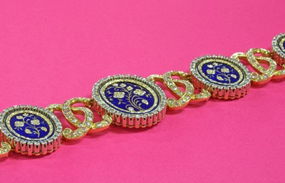 Lot 204 - A two colour gold diamond and enamel plaque bracelet