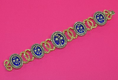 Lot 204 - A two colour gold diamond and enamel plaque bracelet
