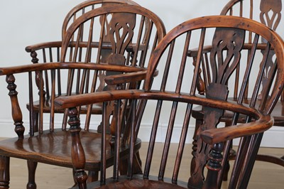 Lot 701 - A matched set of six yew and elm low hoop back Windsor armchairs