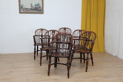 Lot 701 - A matched set of six yew and elm low hoop back Windsor armchairs