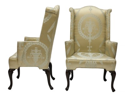 Lot 112 - A pair of wingback armchairs