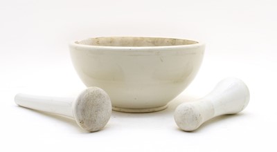 Lot 133 - A large ceramic pestle and mortar and another pestle (3)