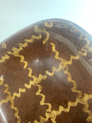 Lot 702 - A Staffordshire pottery slipware baking dish