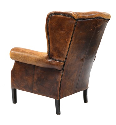 Lot 544 - A George III-style leather wingback armchair