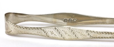 Lot 820 - A pair of George III silver thread pattern sugar tongs