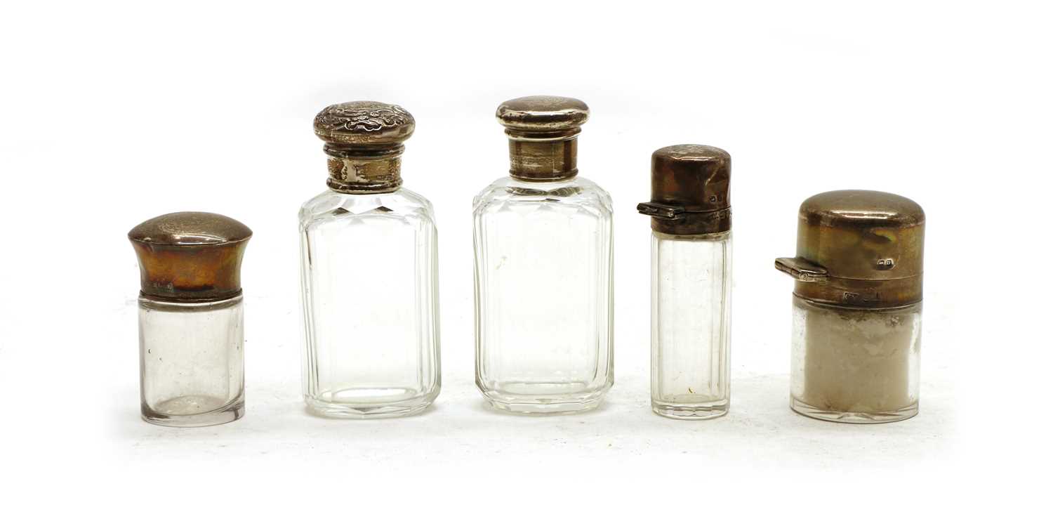Lot 51 - A collection of silver-mounted cut glass dressing table bottles and jars