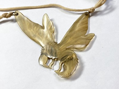 Lot 10 - An Art Nouveau carved horn pendant