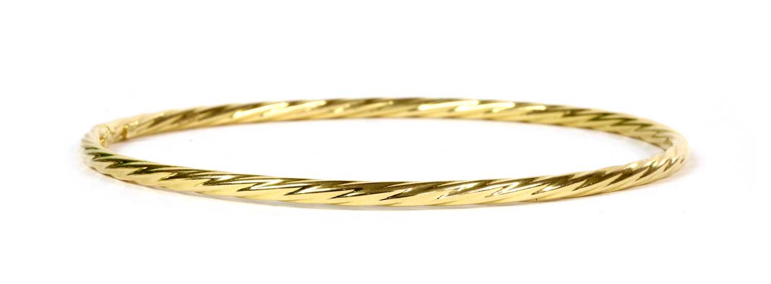 Lot 44 - An 18ct gold hollow twisted wire bangle