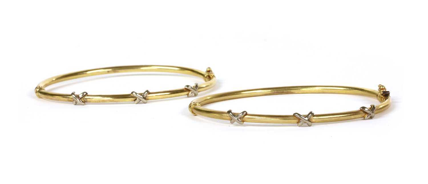 Lot 196 - A pair of 9ct gold hollow hinged bangles