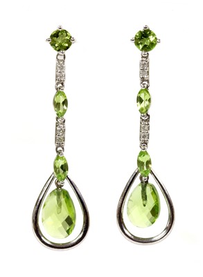 Lot 315 - A pair of 9ct white gold peridot and diamond drop earrings