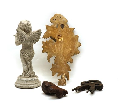 Lot 31 - A carved and painted wooden figure of a cherub playing a flute