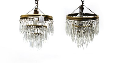 Lot 97 - A pair of cut glass and brass chandeliers of three waterfall graduated tiers