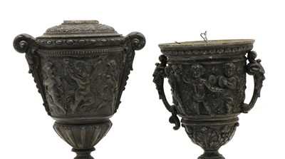 Lot 139 - A cast iron relief twin handled lidded vase