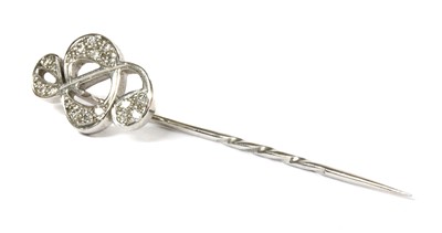 Lot 452 - An 18ct white gold diamond set treble clef stick pin, by Theo Fennell
