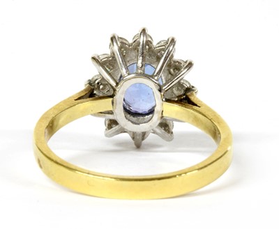 Lot 244 - An 18ct gold tanzanite and diamond cluster ring