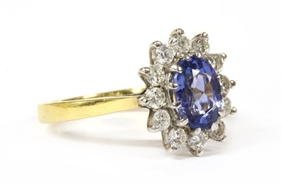 Lot 244 - An 18ct gold tanzanite and diamond cluster ring