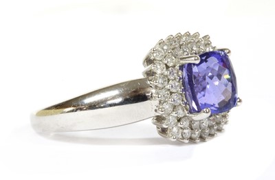 Lot 242 - A 9ct white gold tanzanite and diamond double halo cluster ring