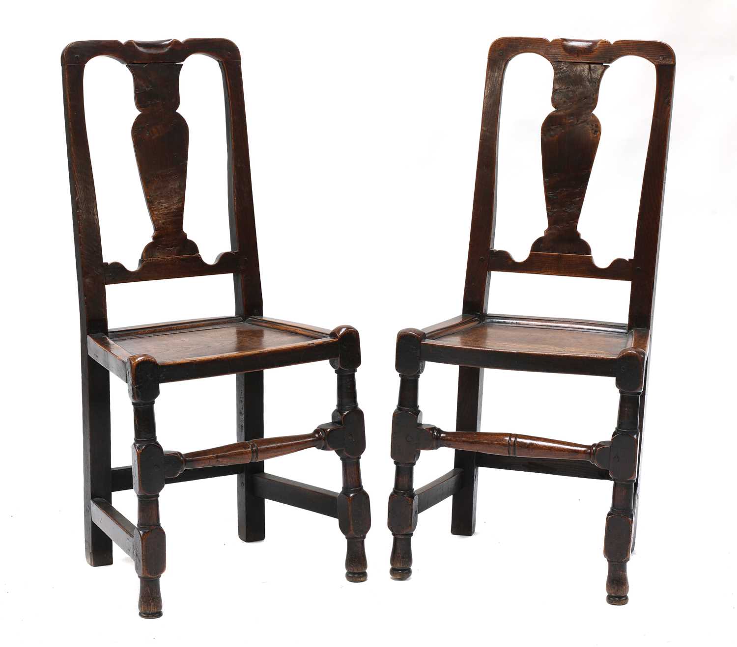 Lot 711 - A pair of George I elm side chairs