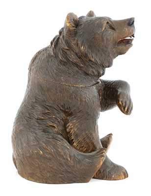 Lot 64 - A Black Forest carved wooden bear tobacco jar