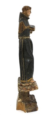 Lot 141 - A carved wooden and painted figure of a monk