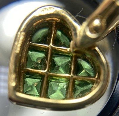 Lot 309 - An 18ct gold tsavorite garnet and diamond heart shaped pendant