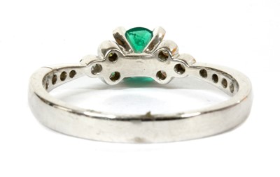 Lot 109 - An 18ct white gold emerald and diamond ring