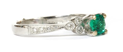 Lot 109 - An 18ct white gold emerald and diamond ring