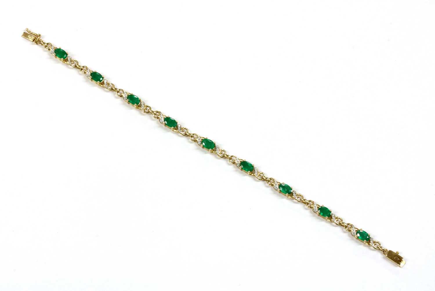 Lot 101 - A 9ct gold emerald and diamond bracelet