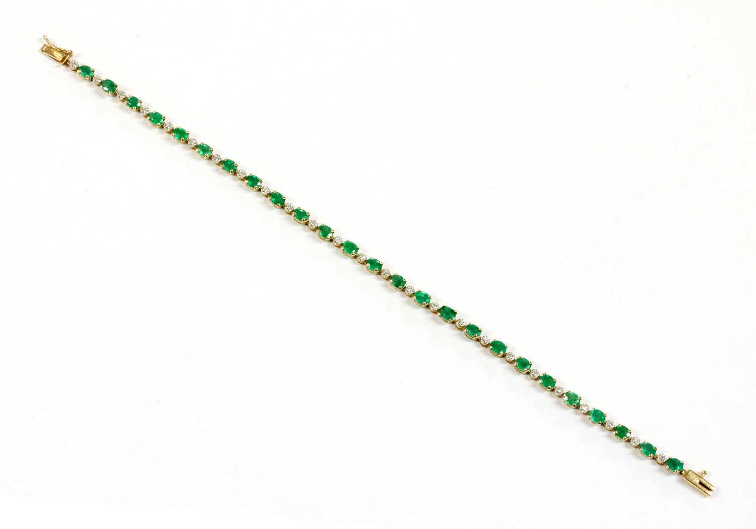 Lot 103 - A 9ct gold emerald and diamond bracelet