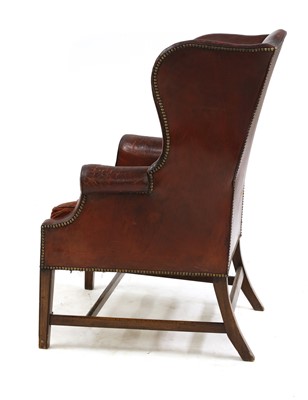 Lot 340 - A George III-style red leather wingback armchair