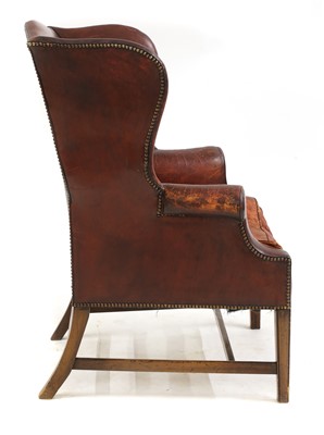 Lot 340 - A George III-style red leather wingback armchair