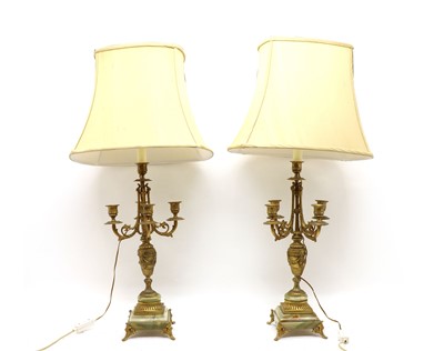 Lot 154 - A pair of gilt metal and onyx table lamps