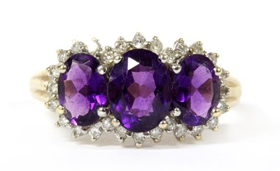 Lot 268 - A 9ct gold amethyst and diamond triple cluster ring