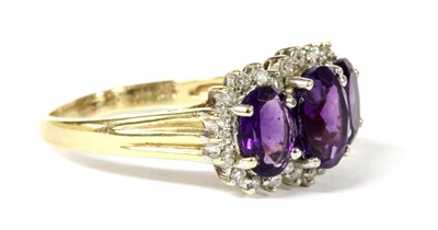 Lot 268 - A 9ct gold amethyst and diamond triple cluster ring