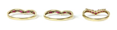 Lot 133 - A pair of 9ct gold ruby and diamond shaped rings