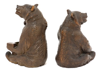 Lot 63 - A near opposing pair of carved Black Forest bear ashtrays