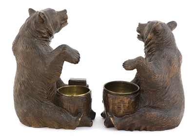Lot 63 - A near opposing pair of carved Black Forest bear ashtrays