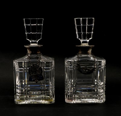 Lot 96 - A pair of glass decanters with silver collars