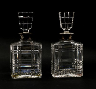 Lot 96 - A pair of glass decanters with silver collars