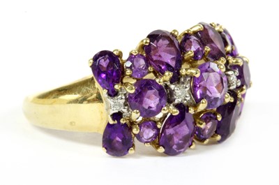 Lot 269 - A 9ct gold three row amethyst and diamond ring