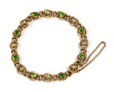 Lot 1 - A Victorian gold demantoid garnet and split pearl curb bracelet