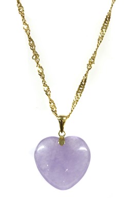 Lot 409 - A carved lavender jade heart pendant