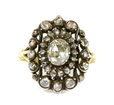 Lot 174 - A gold and silver diamond oval cluster ring