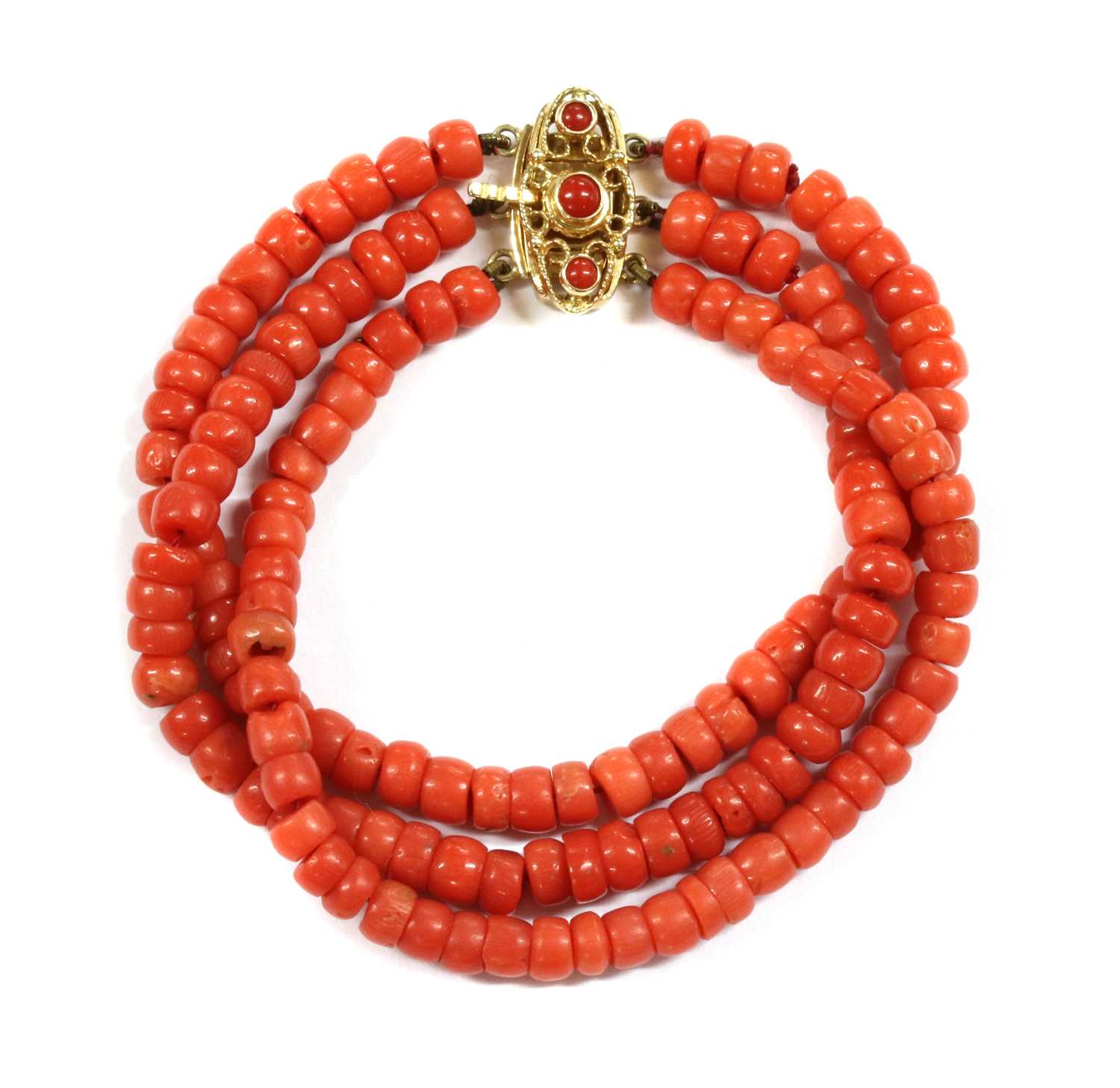 Lot 24 - A three row uniform coral bead bracelet